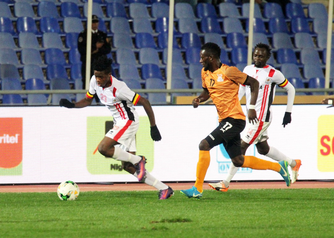 Milton Karisa dribbles away from Kabaso Mulenga (shirt 17) during the match