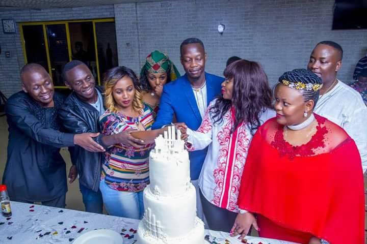 Kusasira and Seruga fronted by artistes cutting the cake at the introduction