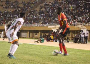 Joseph Ochaya attempting to dribble past Niger player